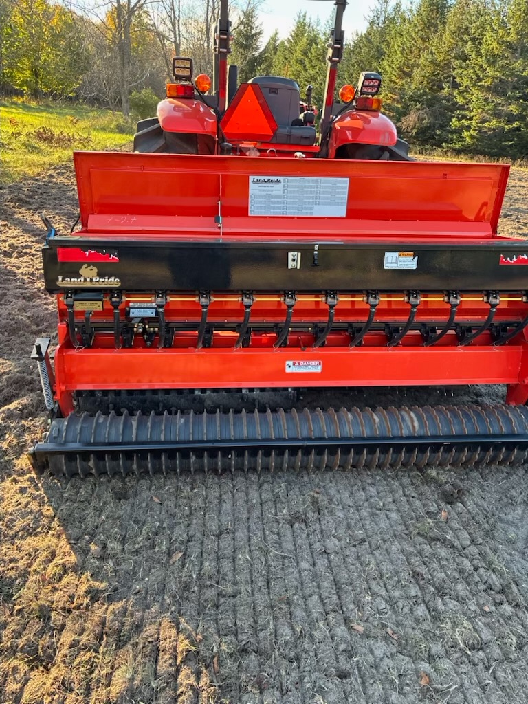 Land Pride seed drill poised over freshly tilled soil, ready to plant the native wildflower mix