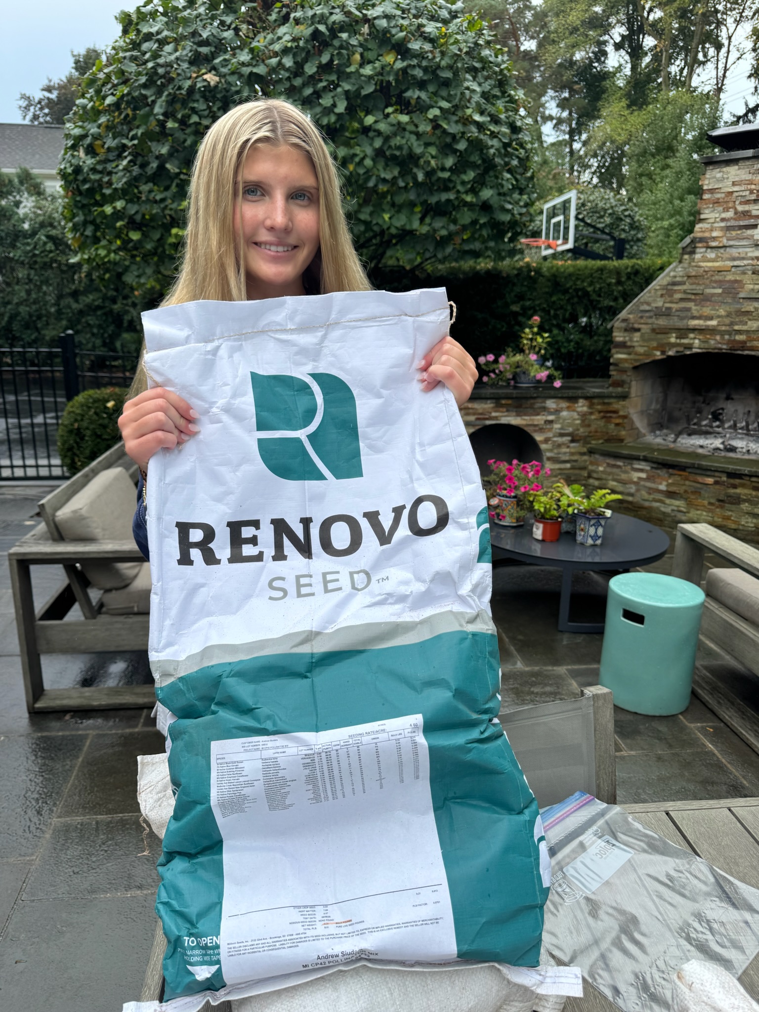 Holding a bag of Renovo Seed native wildflower mix sourced for the waystation